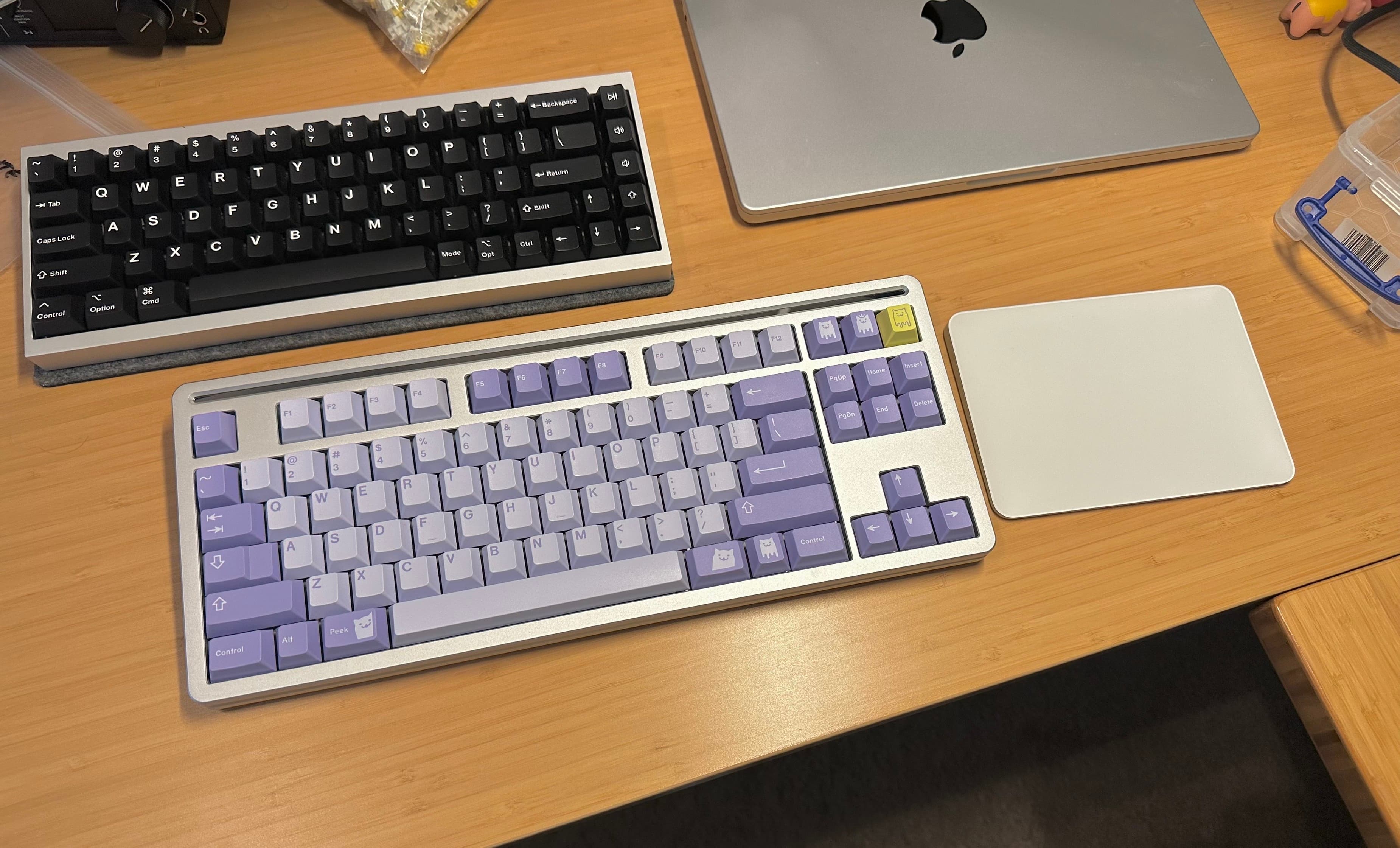 My desk, made from sleek bamboo wood, with the Mode Loop. It's next to a Magic Trackpad 2. The keyboard above is a Tofu65 2.0 in Anodized Silver.